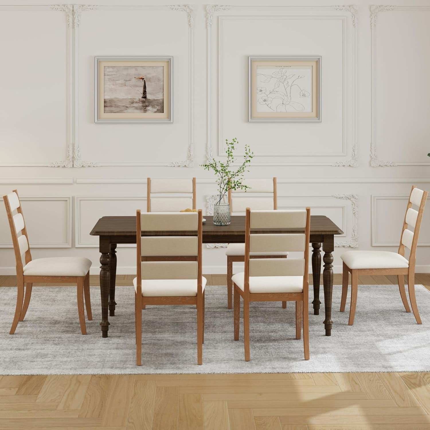 Dining room with wooden table and chairs against a white wall.