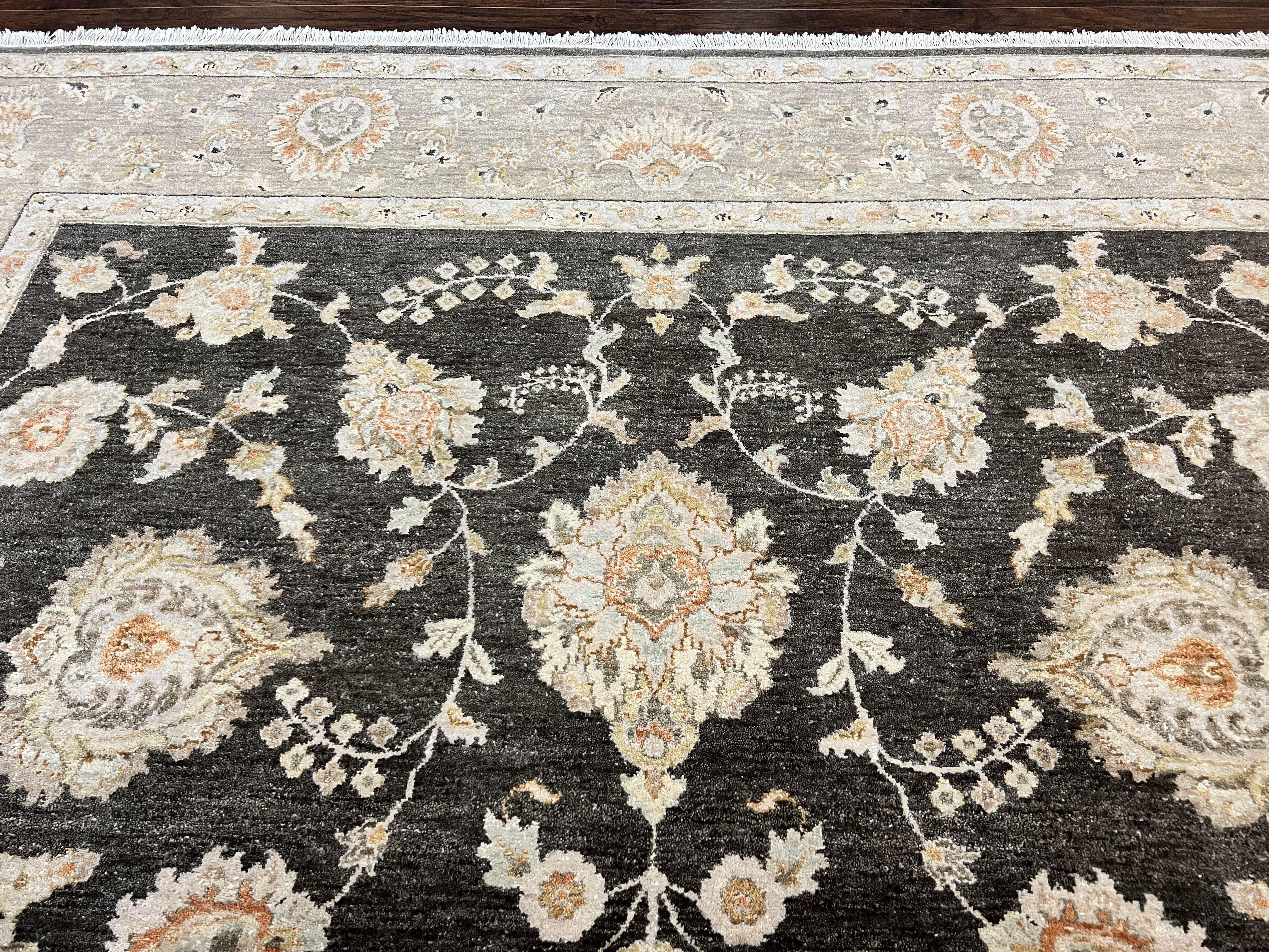 Close-up of a floral patterned rug with intricate designs on a dark background.
