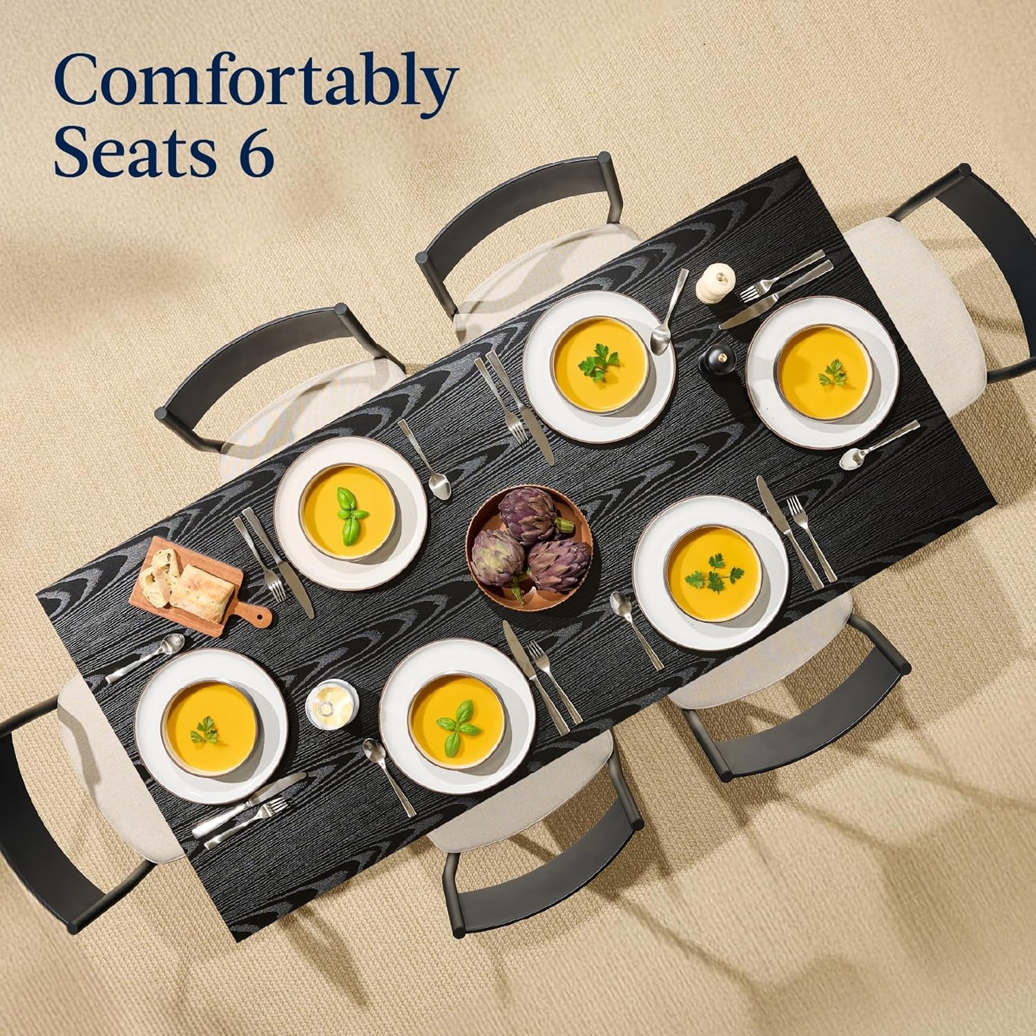 Dining table set for six with plates of food and cutlery on a beige background.