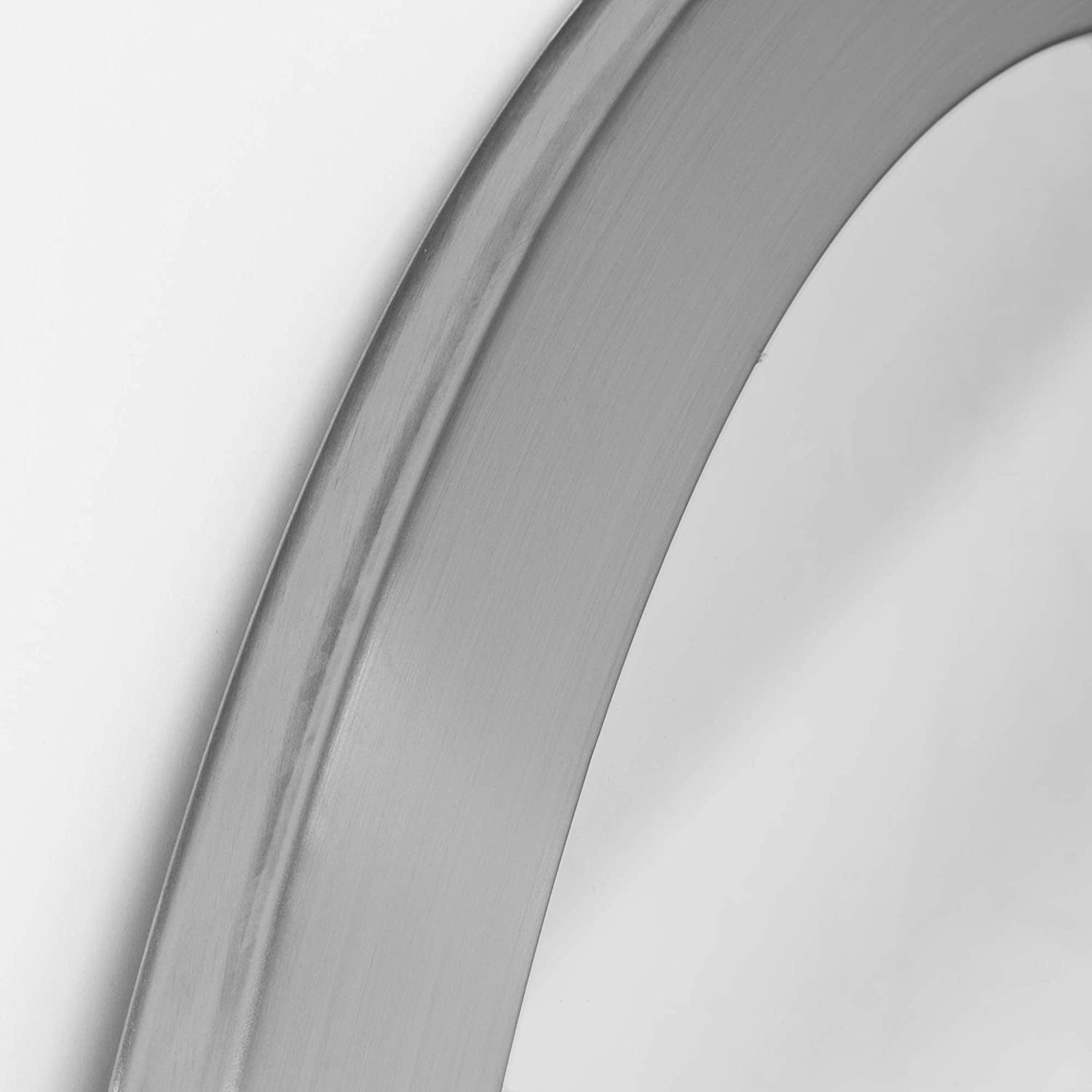Close-up of a metallic object with a reflective surface on a white background