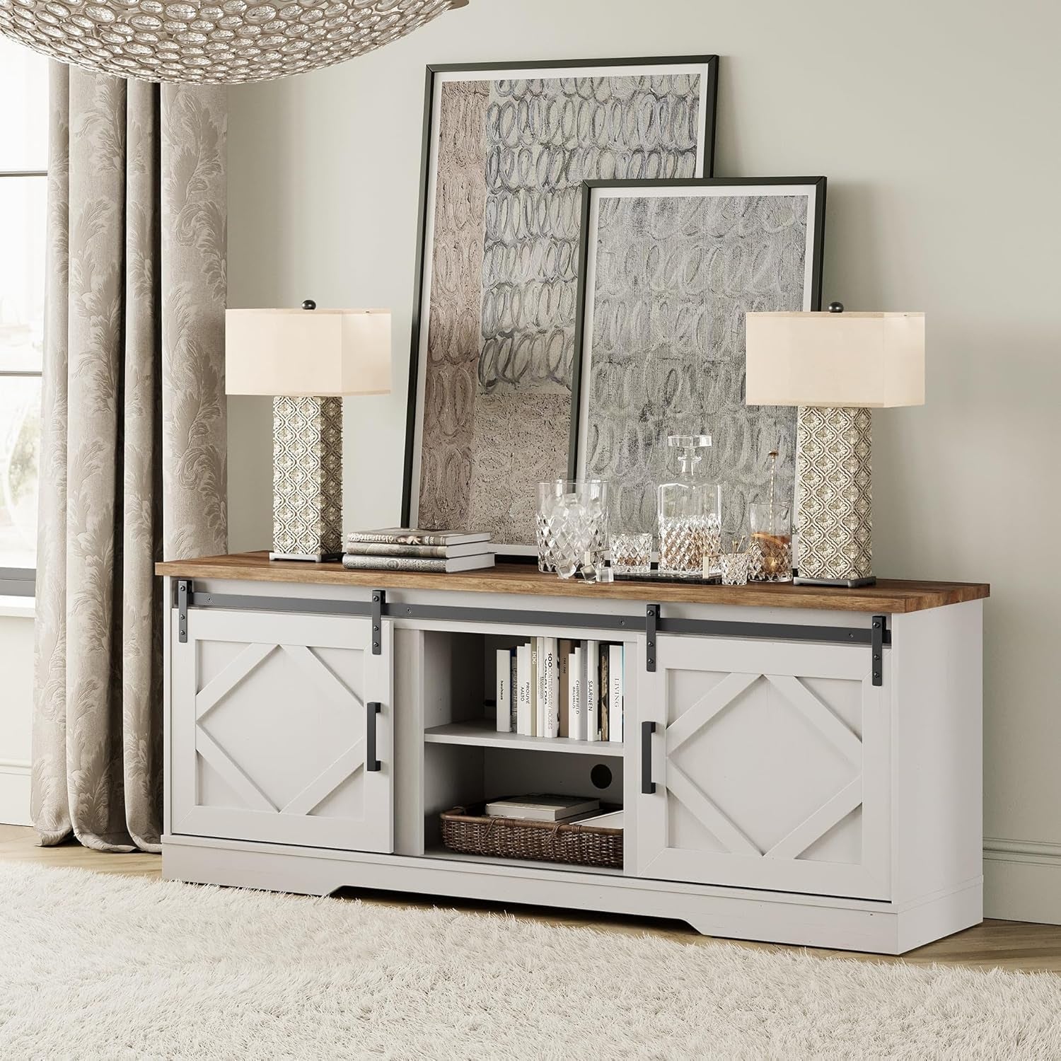 White entertainment console with wooden top, lamps, and decor in a room.