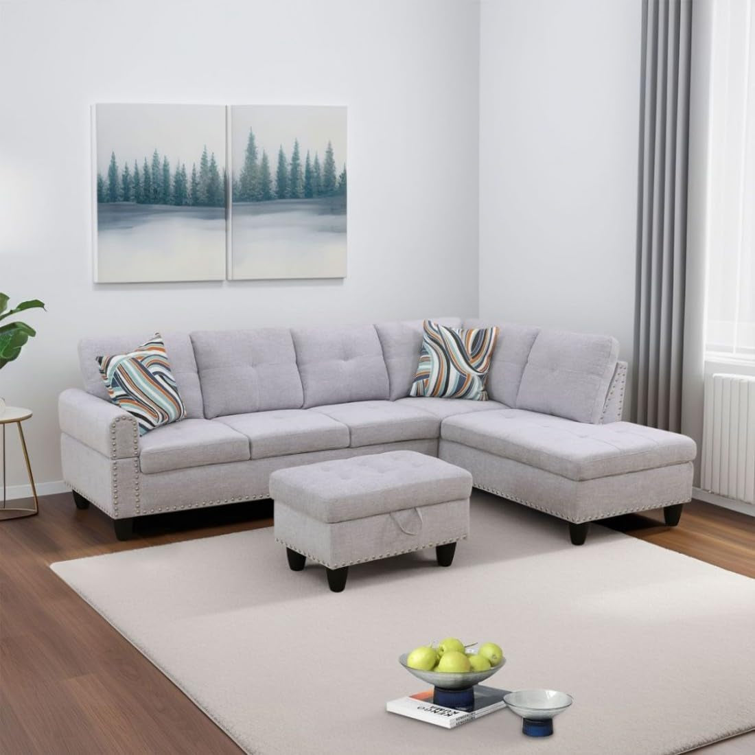 Gray sectional sofa with ottoman in a living room setting.