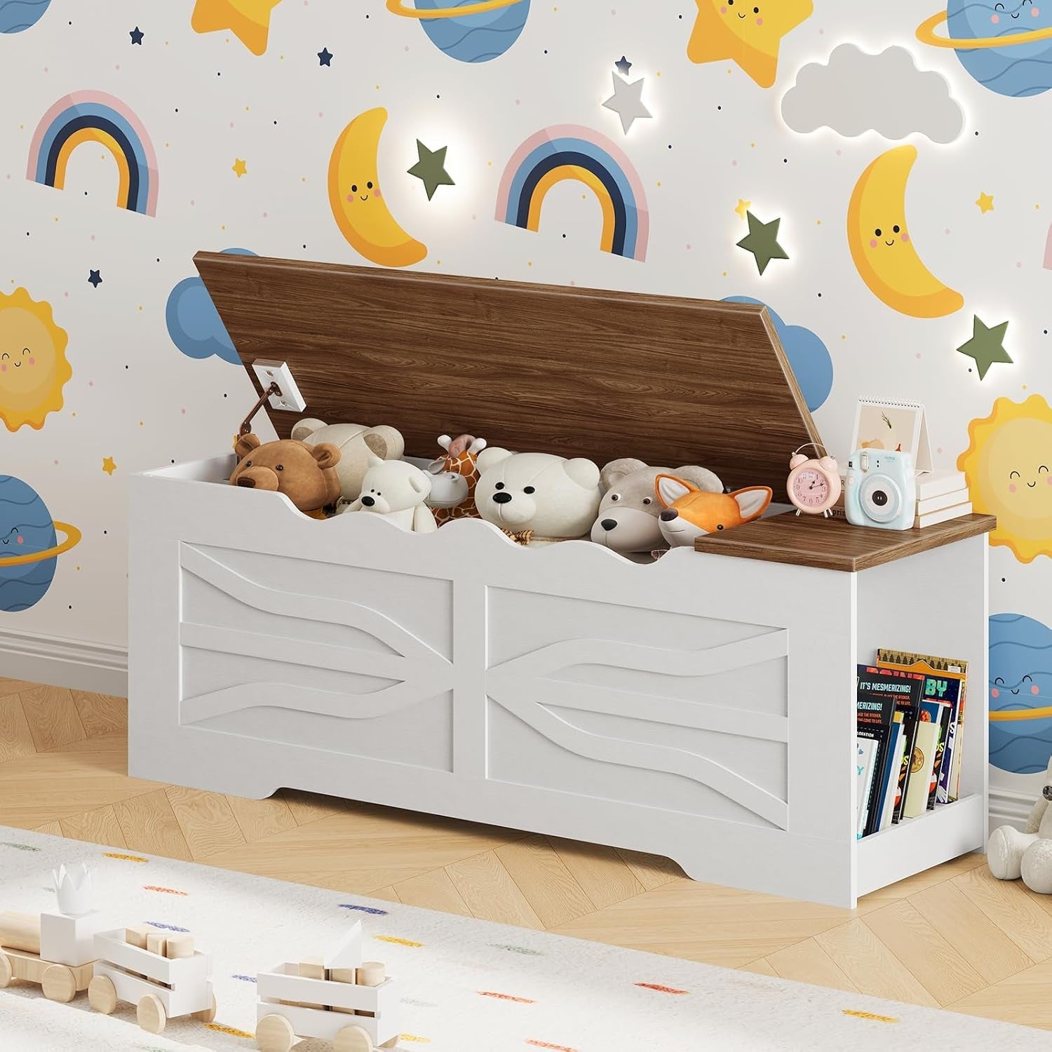 Toy storage bench with stuffed animals and books against a colorful wall with moon, star, and rainbow designs.
