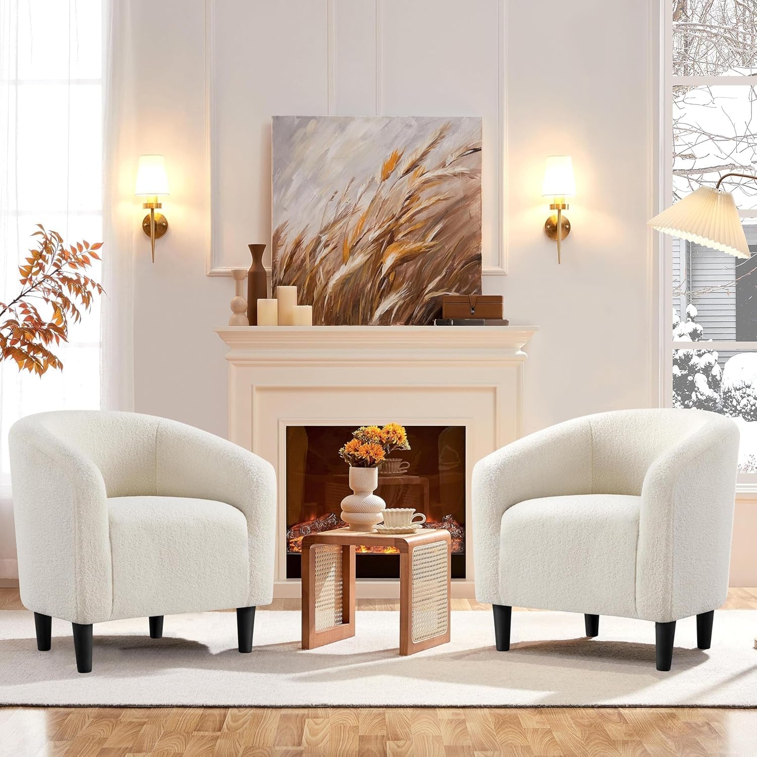Two white armchairs in a living room with a fireplace and decorative items.
