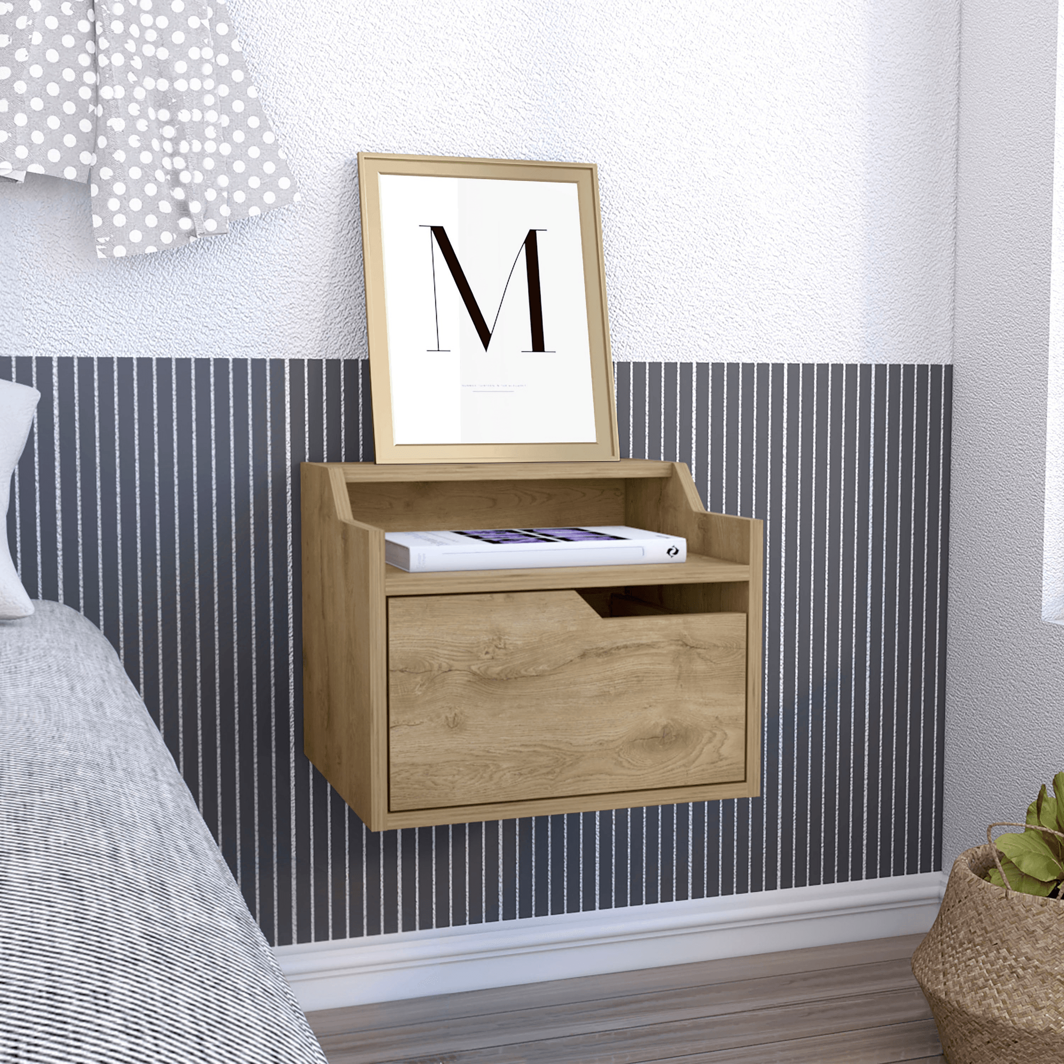 Wooden nightstand with a drawer and framed picture against a striped wall.