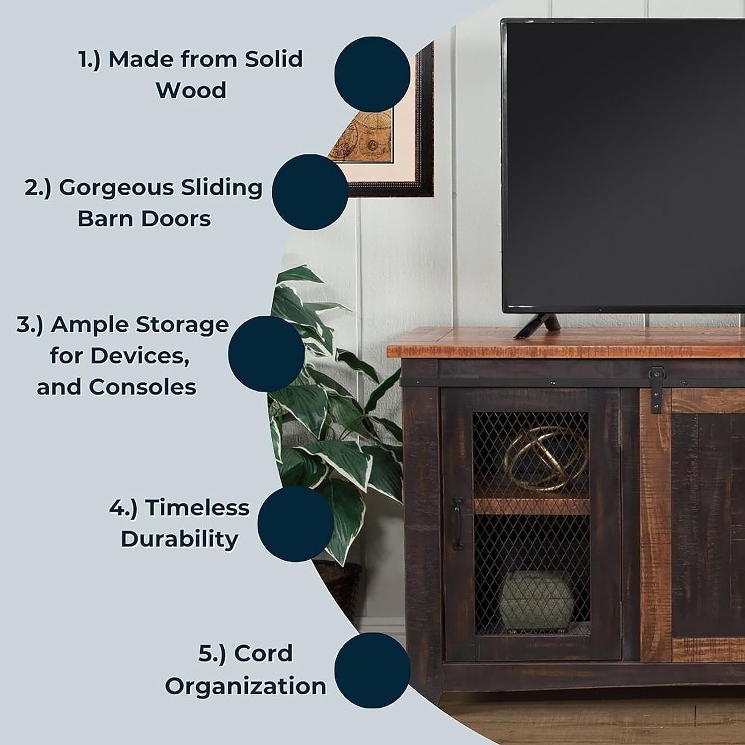 Wooden entertainment console with sliding barn doors, TV on top, and plant beside it.