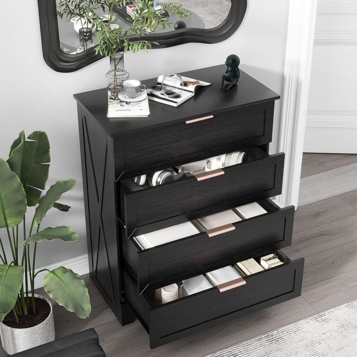Black dresser with open drawer in a room setting with plants and decor items.