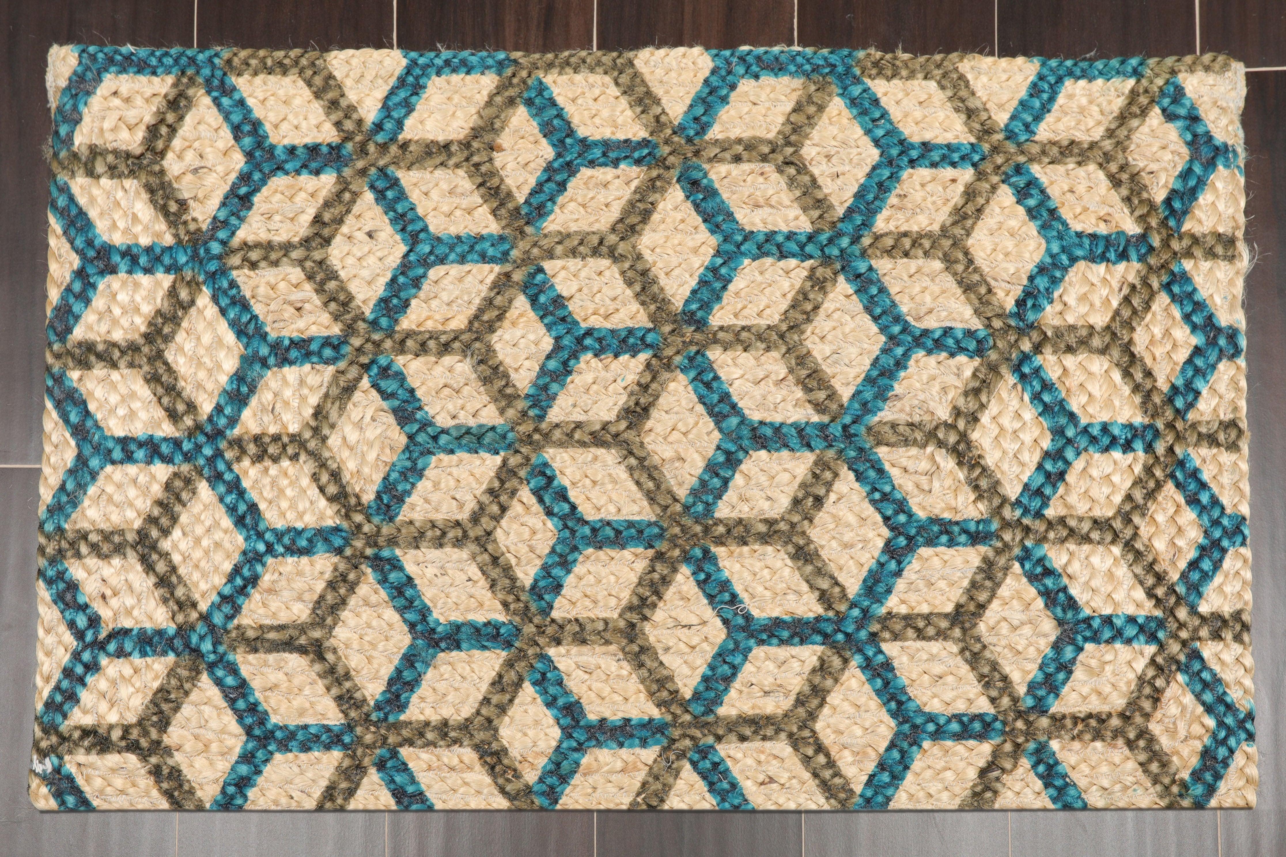 Geometric patterned rug with blue and brown colors on a wooden floor.