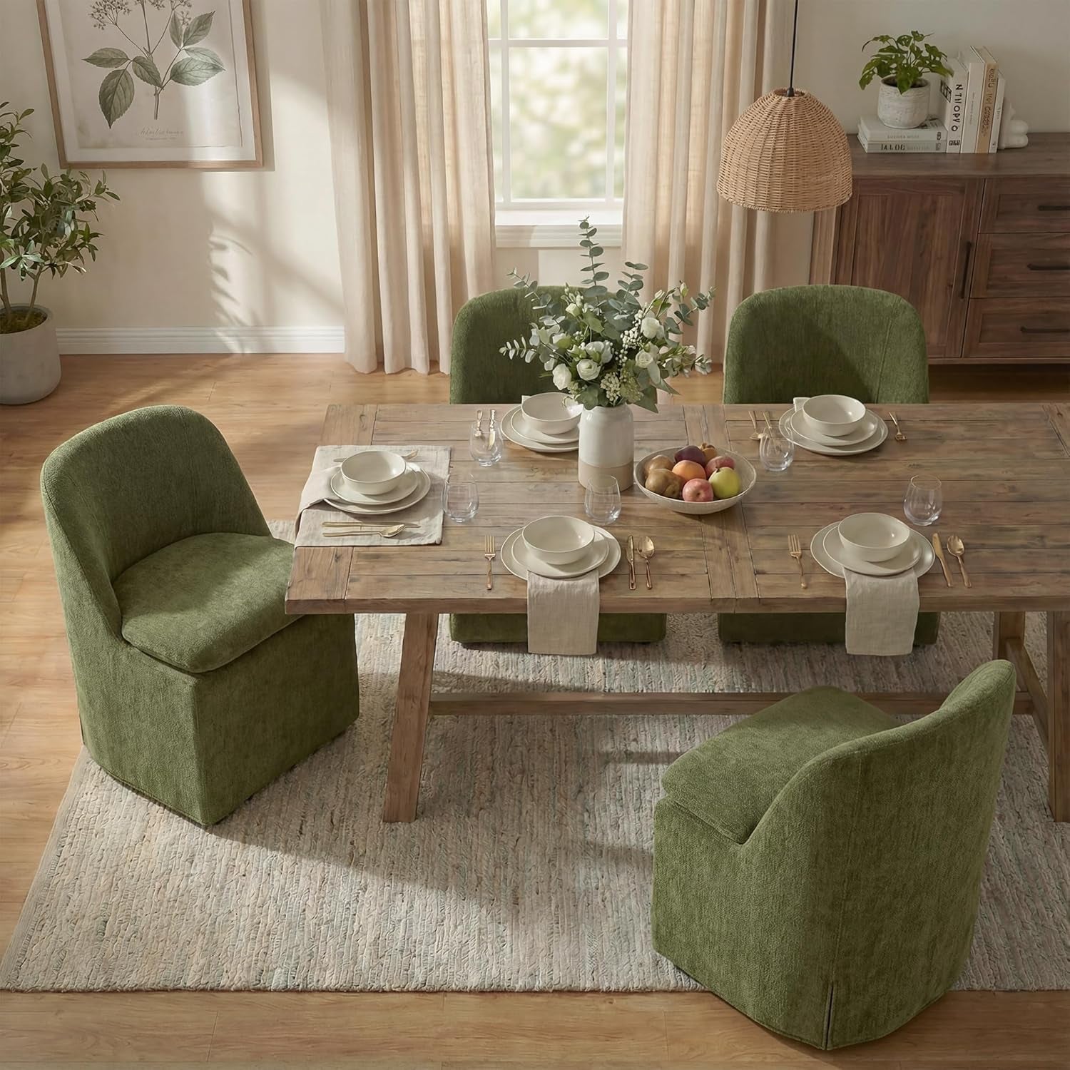 Dining room with wooden table set for a meal, surrounded by green chairs.