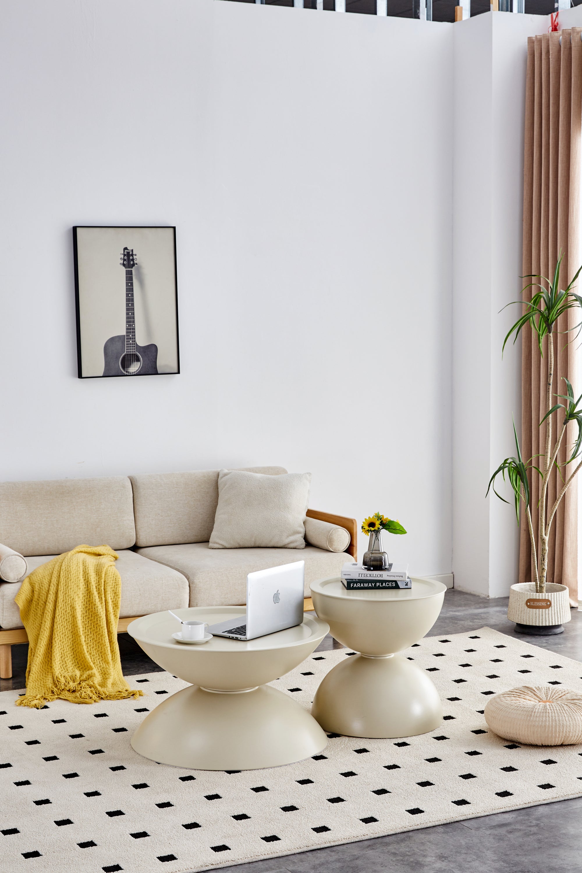 Modern living room with a beige sofa, coffee table, and decorative items.