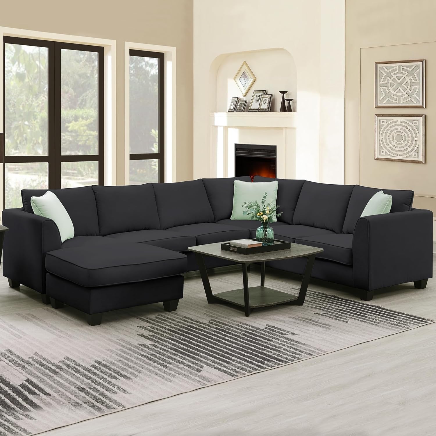 Living room with a black sectional sofa, coffee table, and decorative elements.