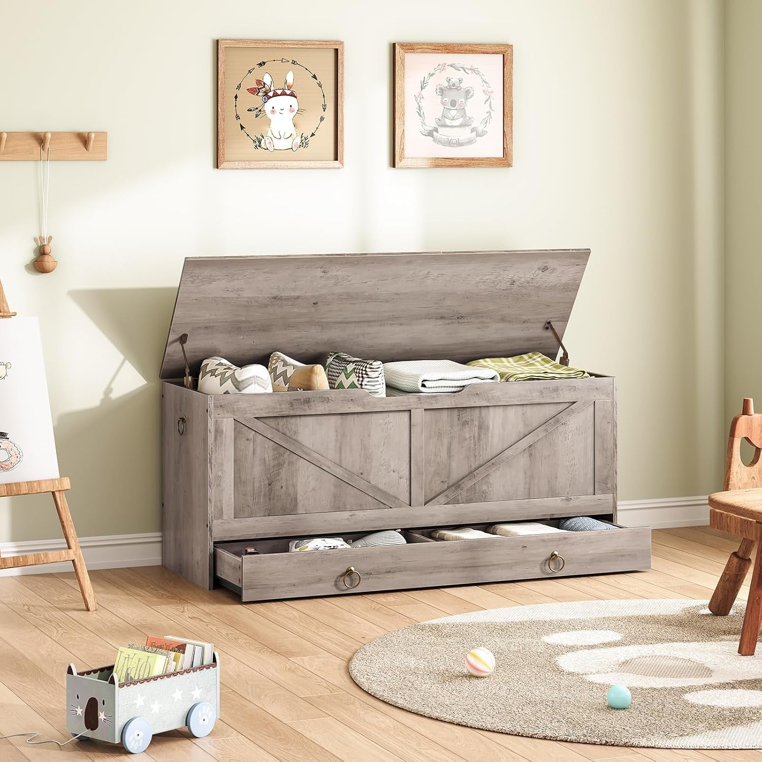 Wooden storage bench with open lid filled with items in a room with light green walls and wooden flooring.