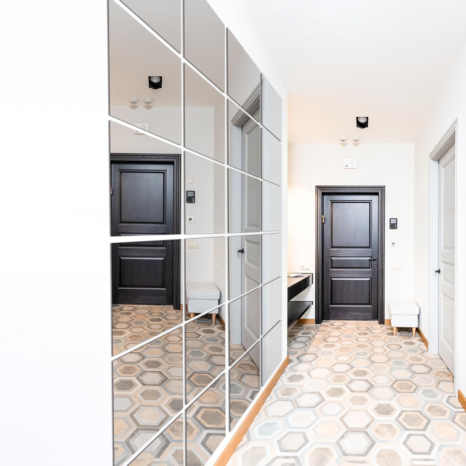 Modern interior with mirrored wall panels and geometric patterned floor.