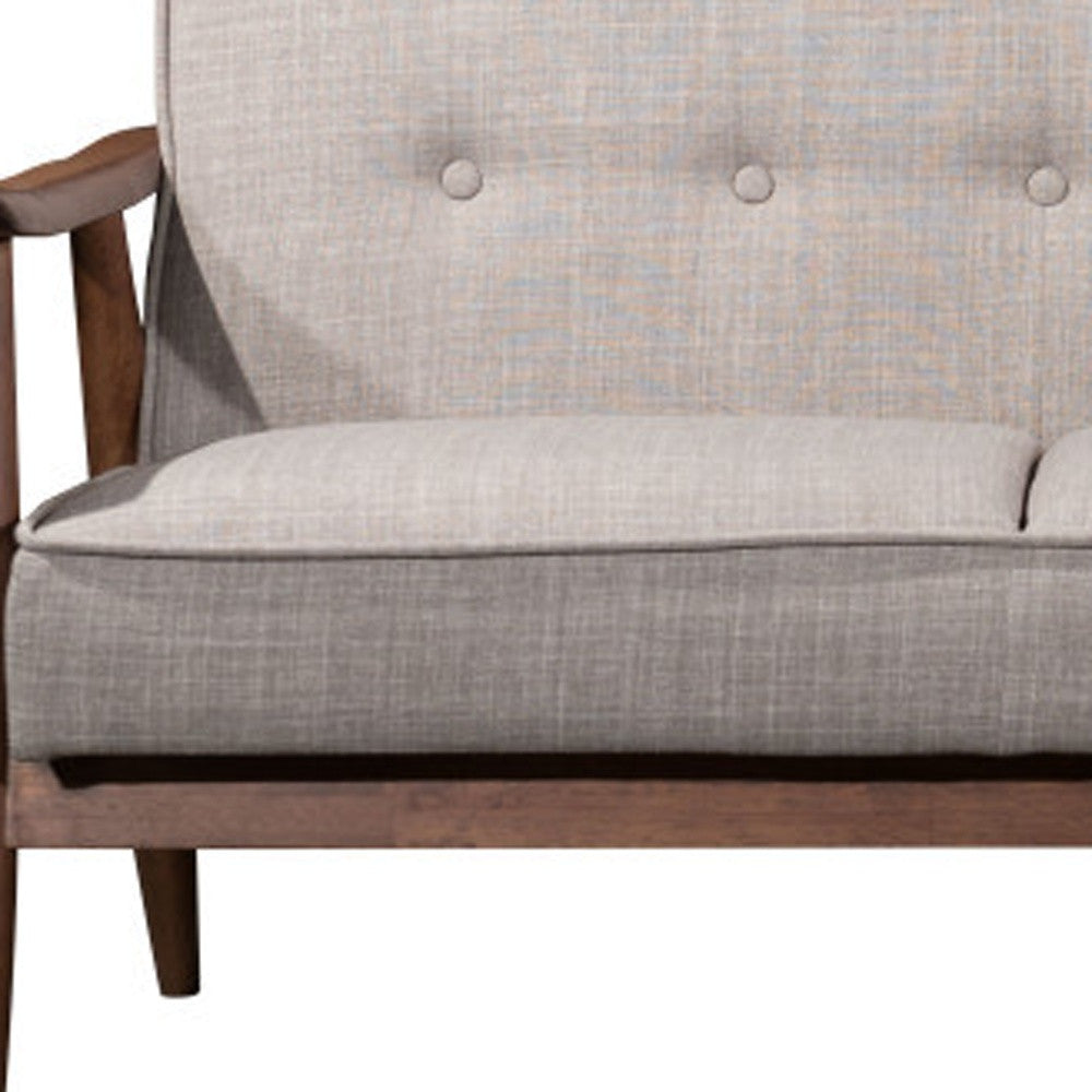 Gray upholstered chair with wooden frame on a white background
