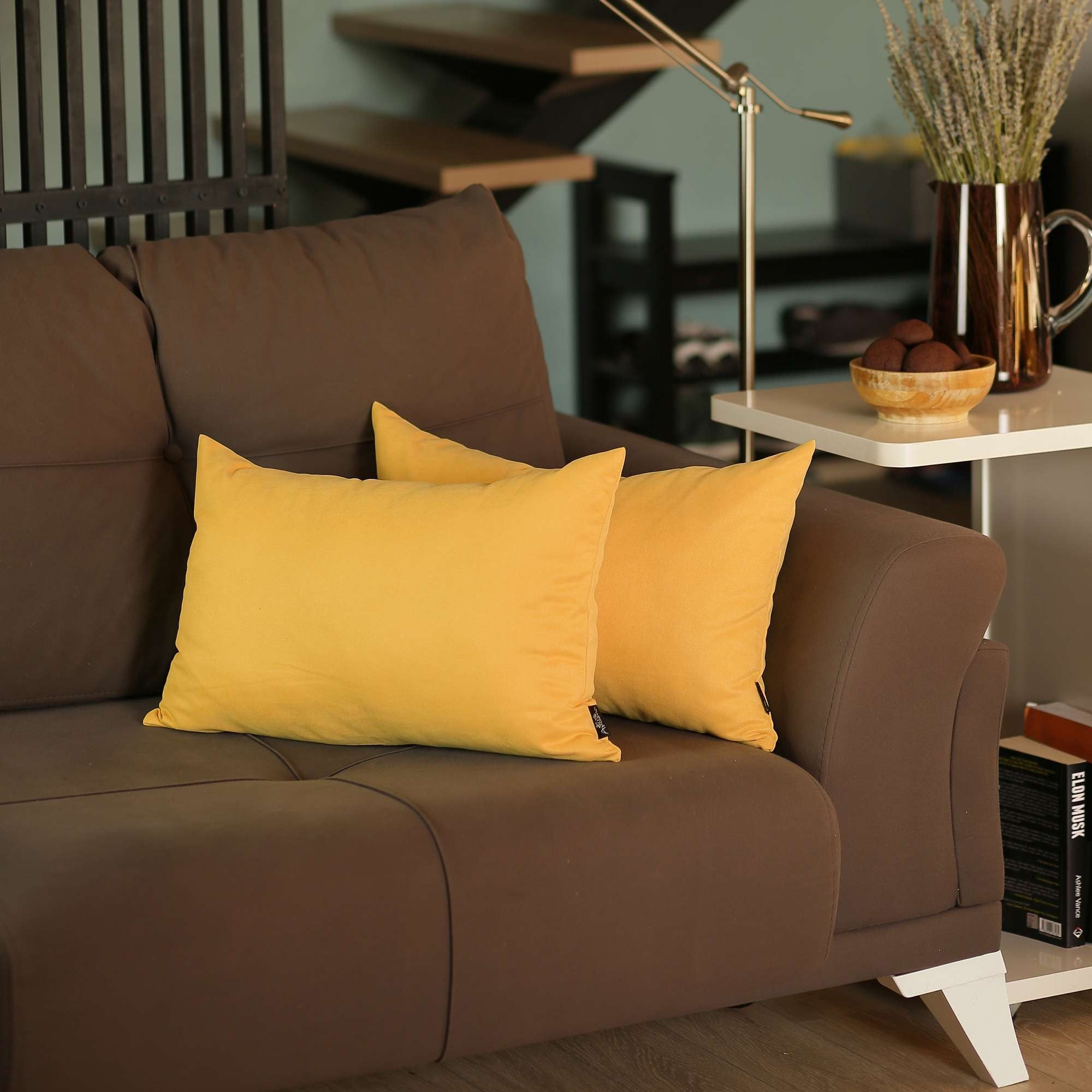 Brown sofa with yellow cushions in a living room setting
