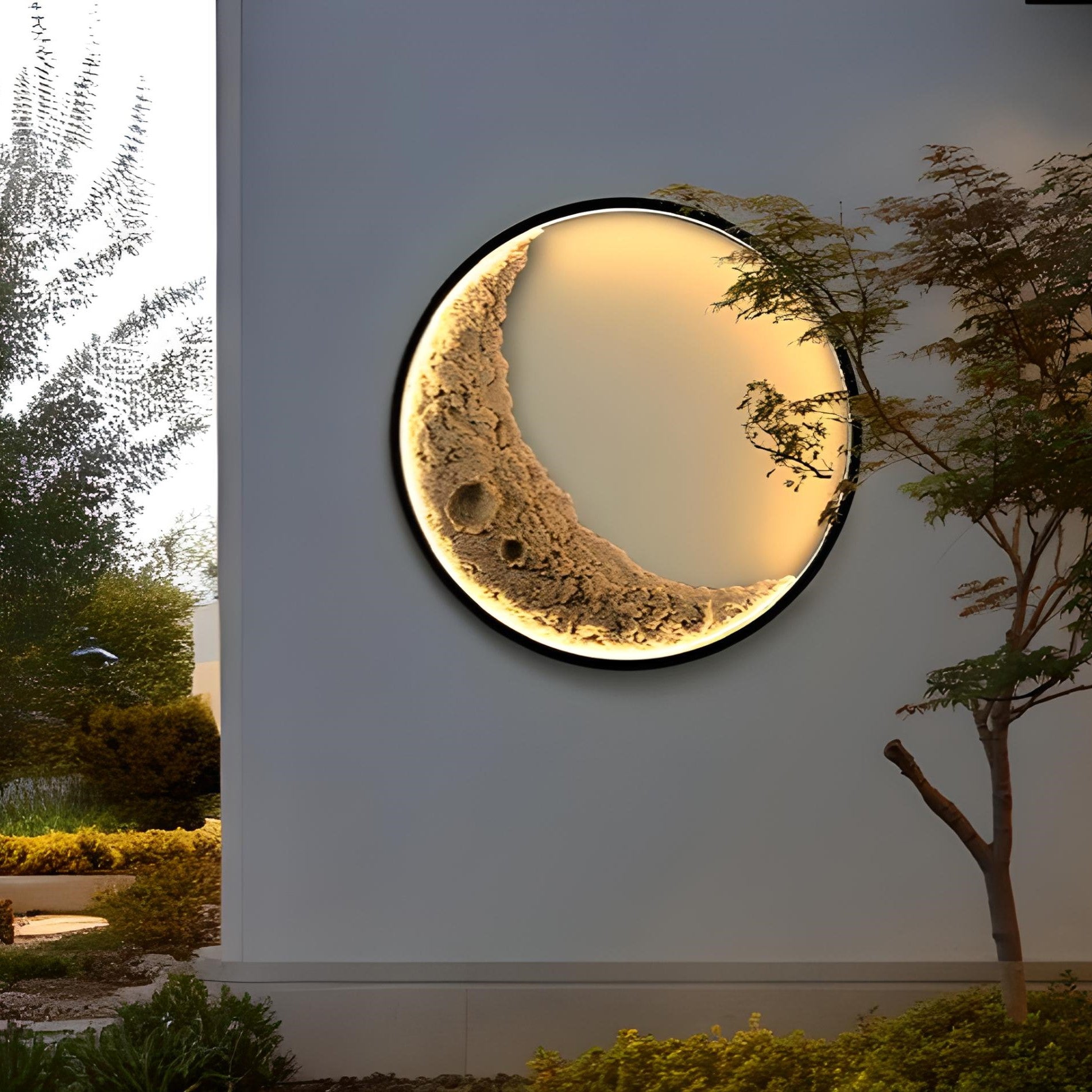 Moon-shaped wall light fixture on a white wall with outdoor scenery.