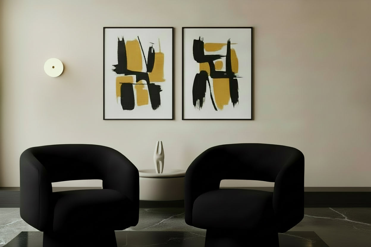 Two black chairs in a room with warm lighting.