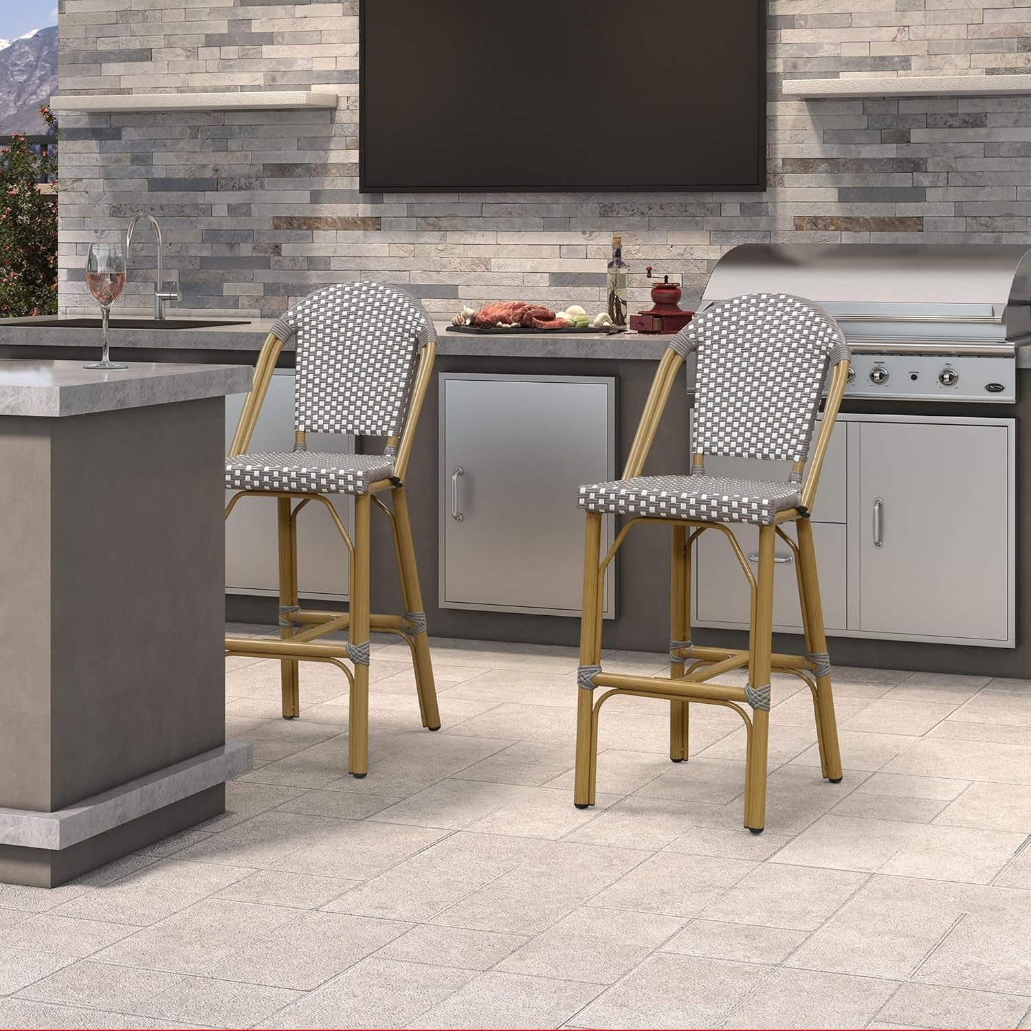 Two bar stools with patterned seats in an outdoor kitchen setting.
