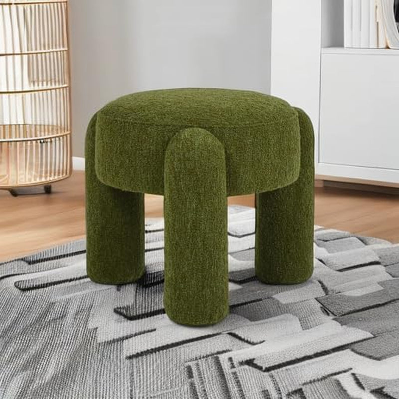Green textured stool on a patterned rug in a room with a white cabinet and wooden floor.