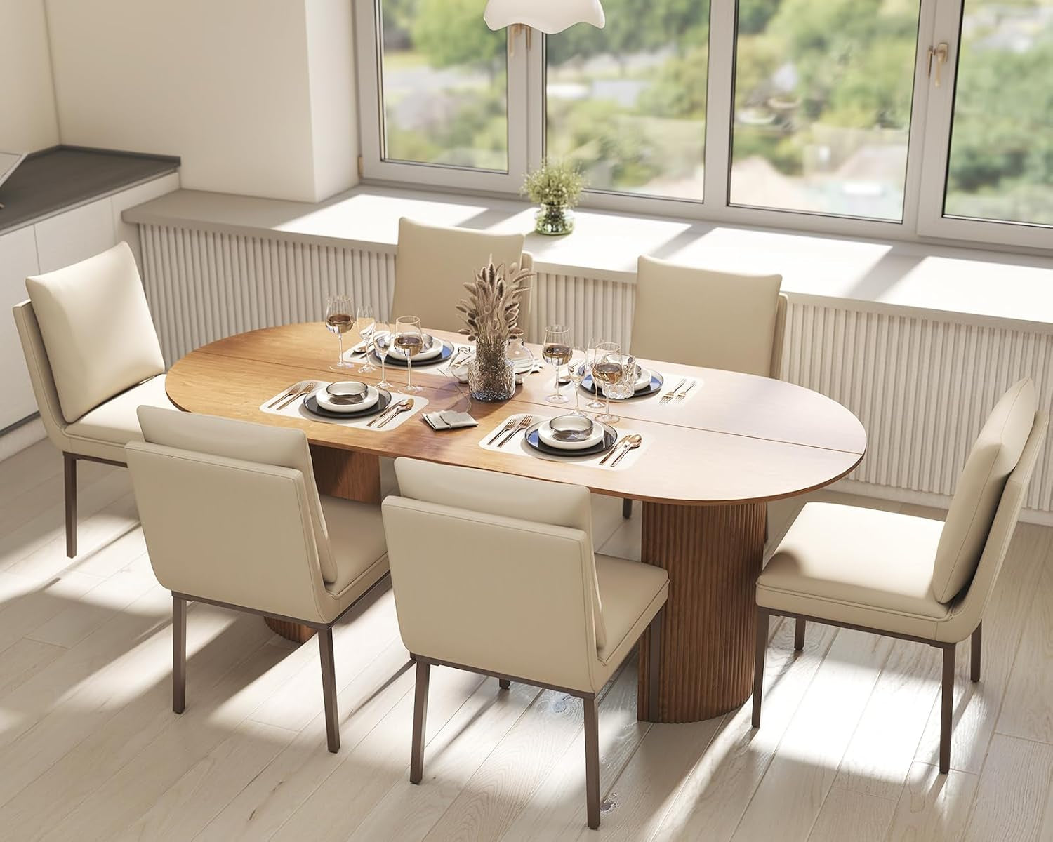 Dining table set with plates and cutlery in a bright room with large windows.