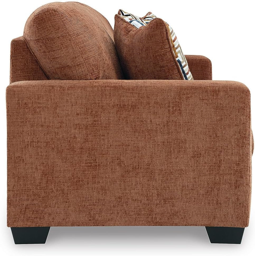 Brown armchair with patterned cushions on a white background