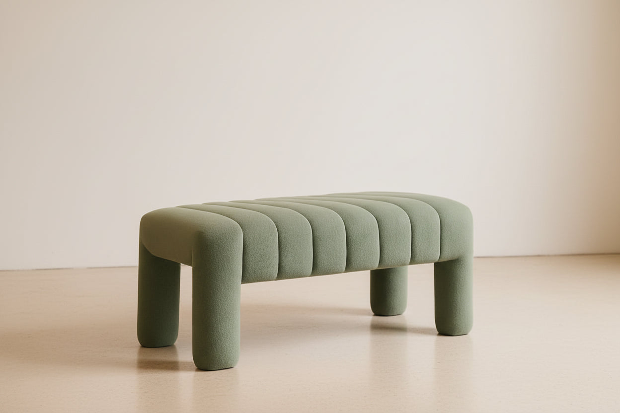 Green upholstered bench in a room with a warm color palette