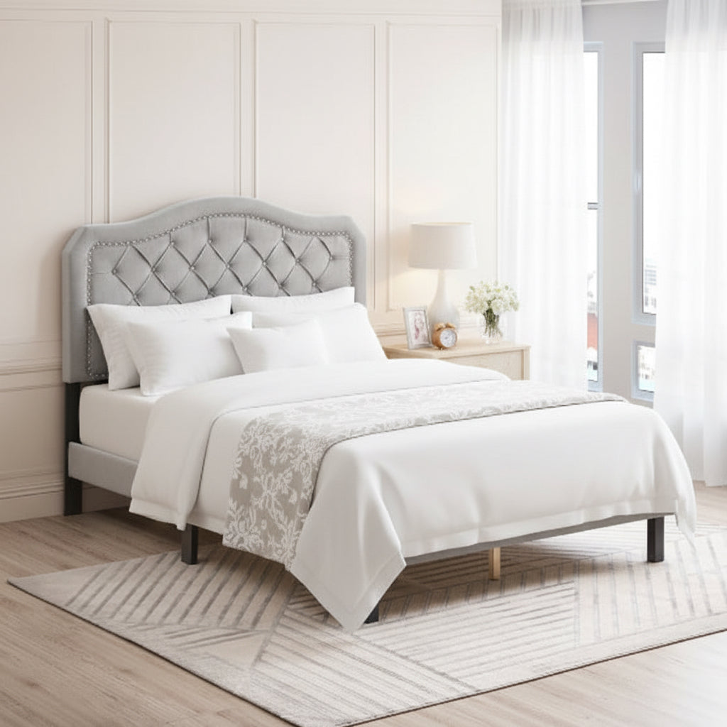 Bedroom with a tufted headboard bed and decorative pillows.