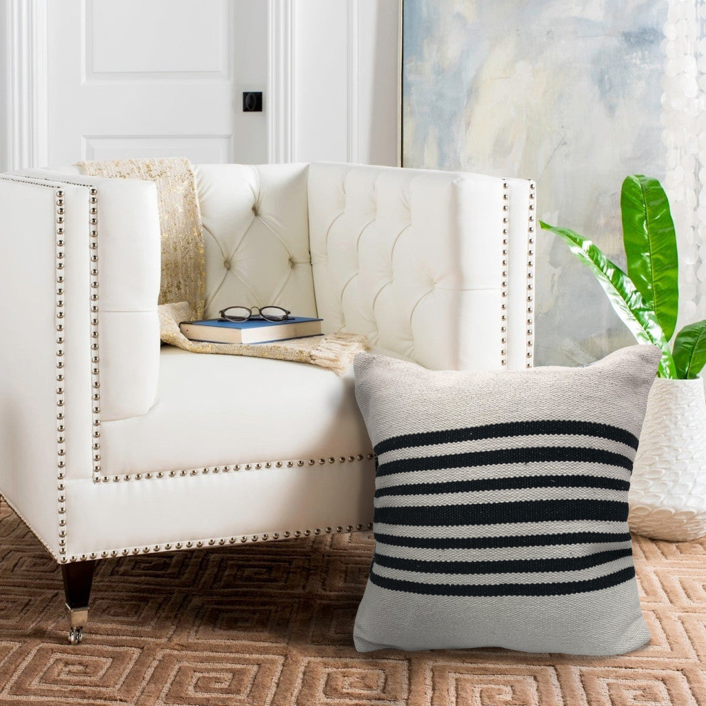 White sofa with a striped pillow in a living room setting