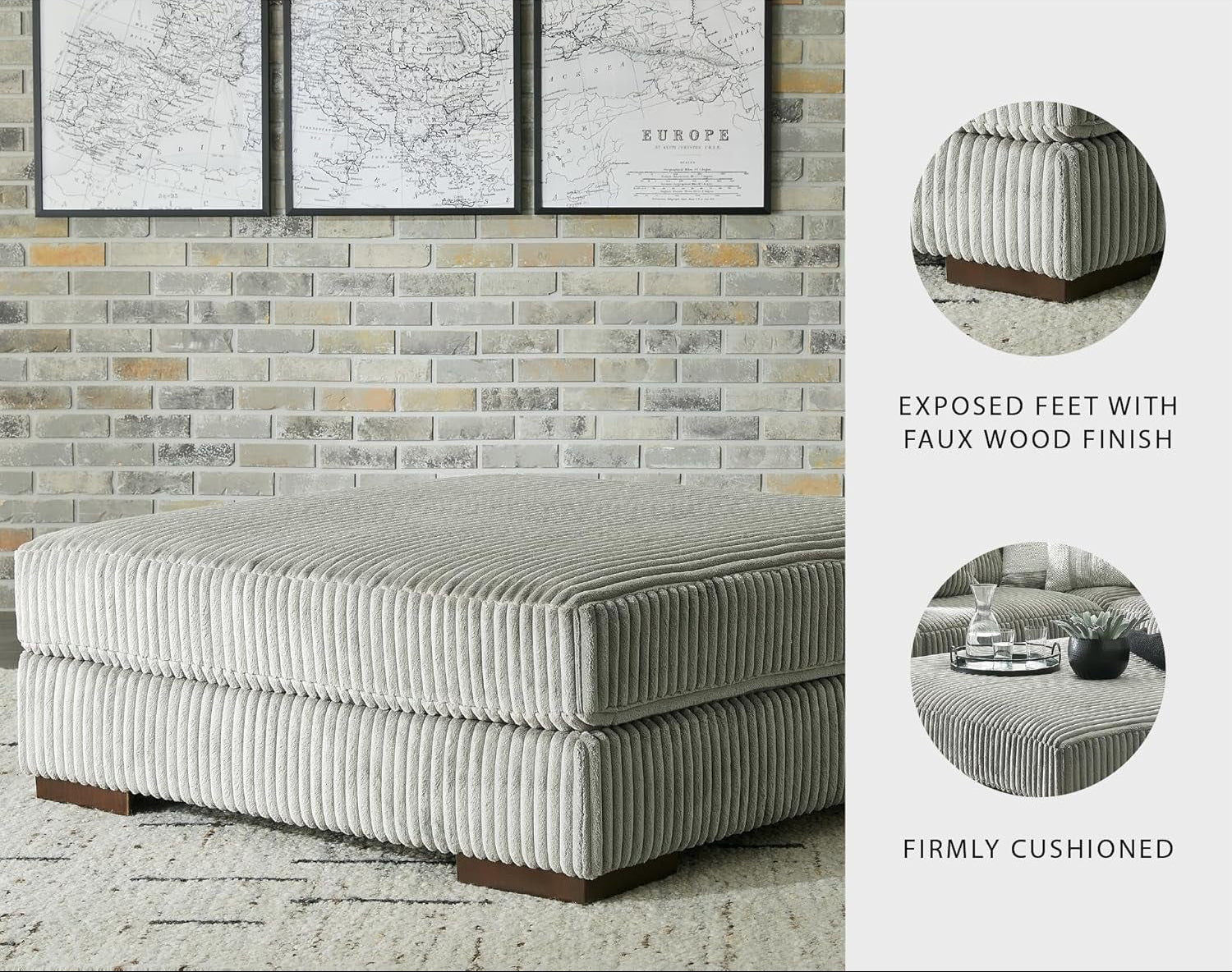 Gray upholstered ottoman with exposed feet and faux wood finish in a living room setting.