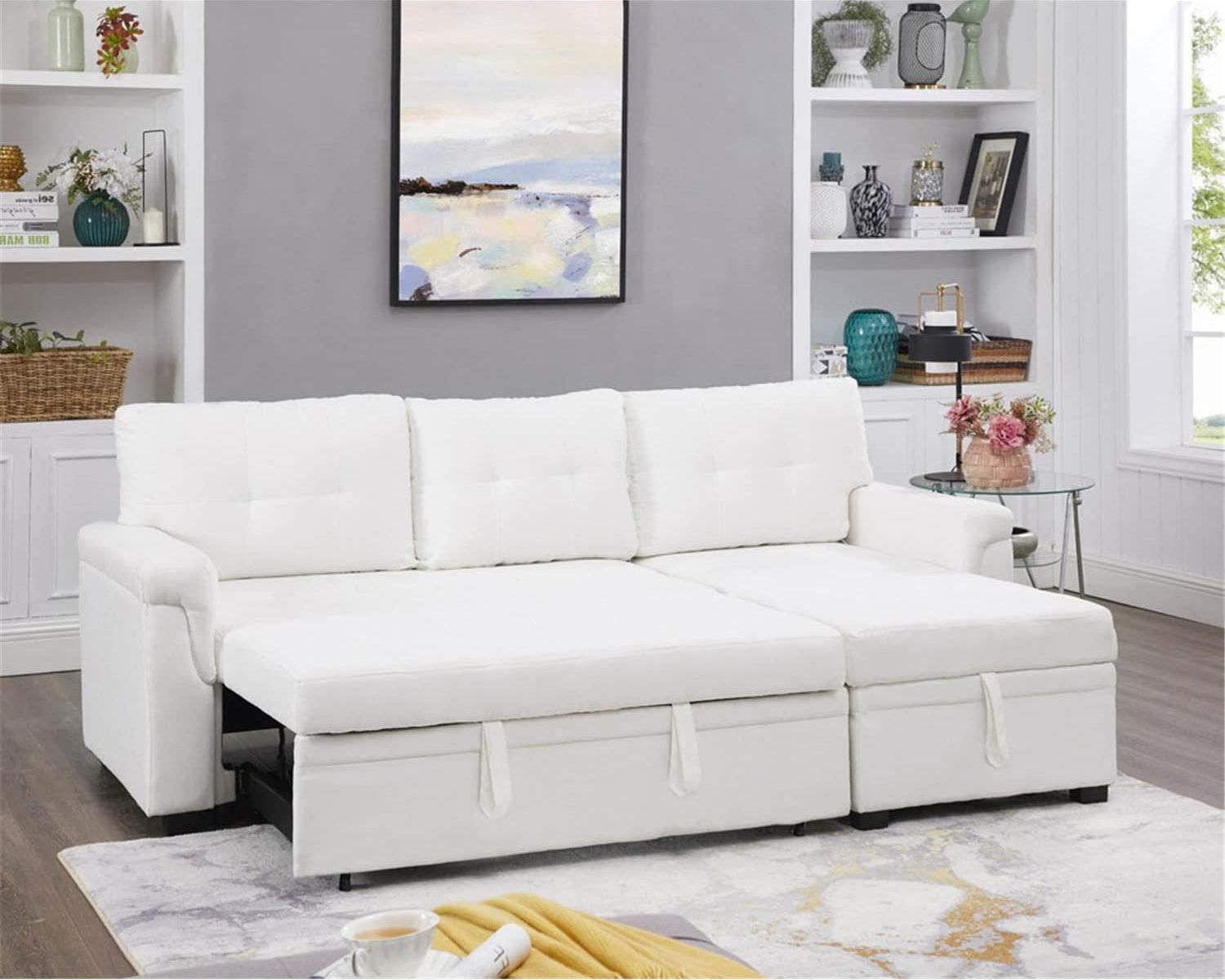 White sectional sofa in a living room setting with decor elements.