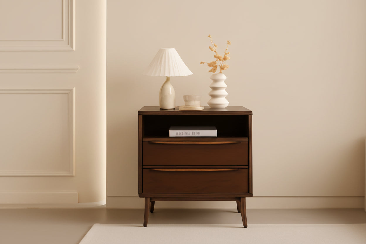 Wooden nightstand with decorative items against a peach wall