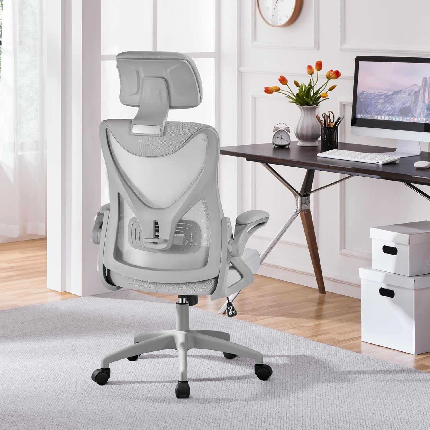 Gray office chair in a home office setting with a desk and computer.