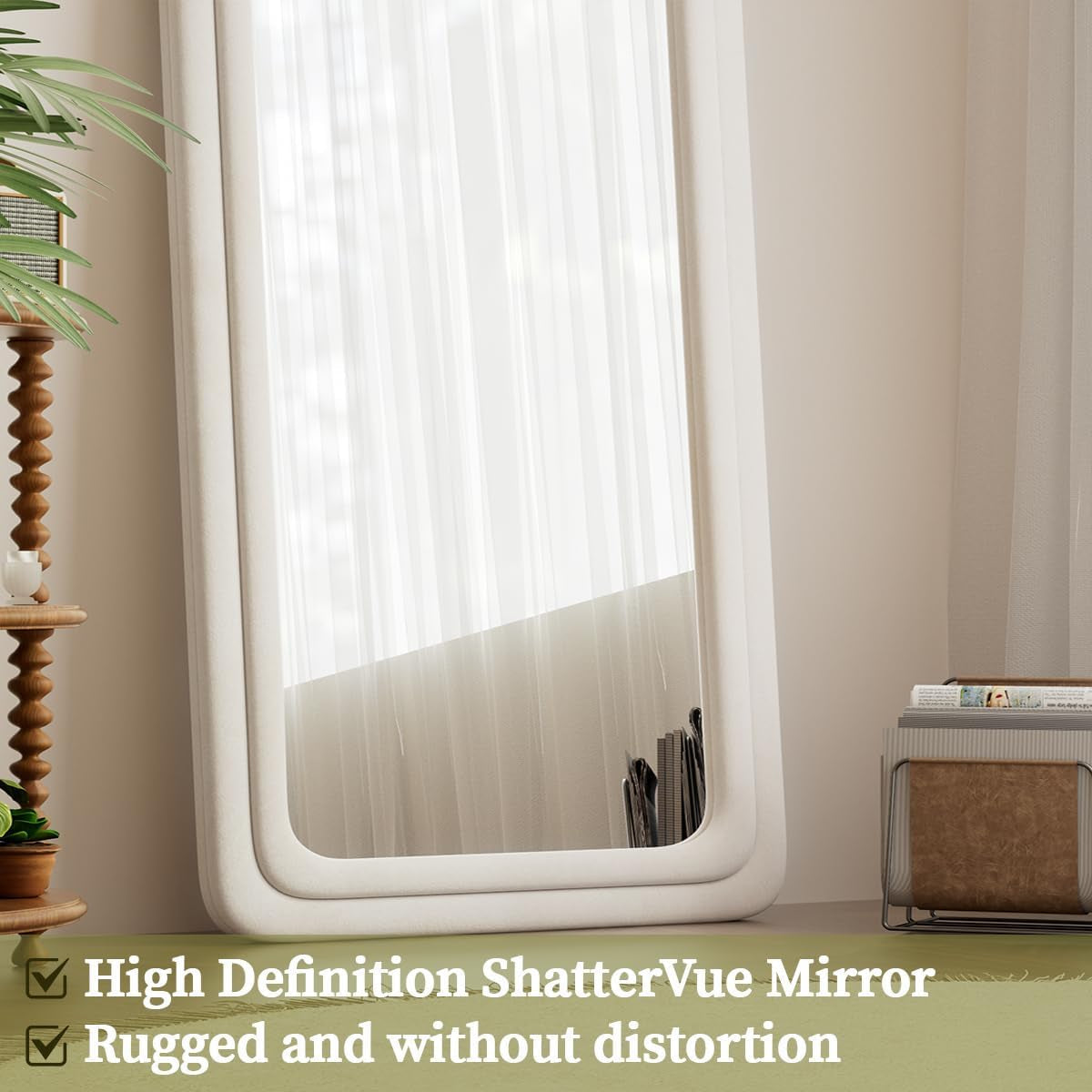 Large mirror with white frame on a beige wall, next to a wooden shelf and plant.