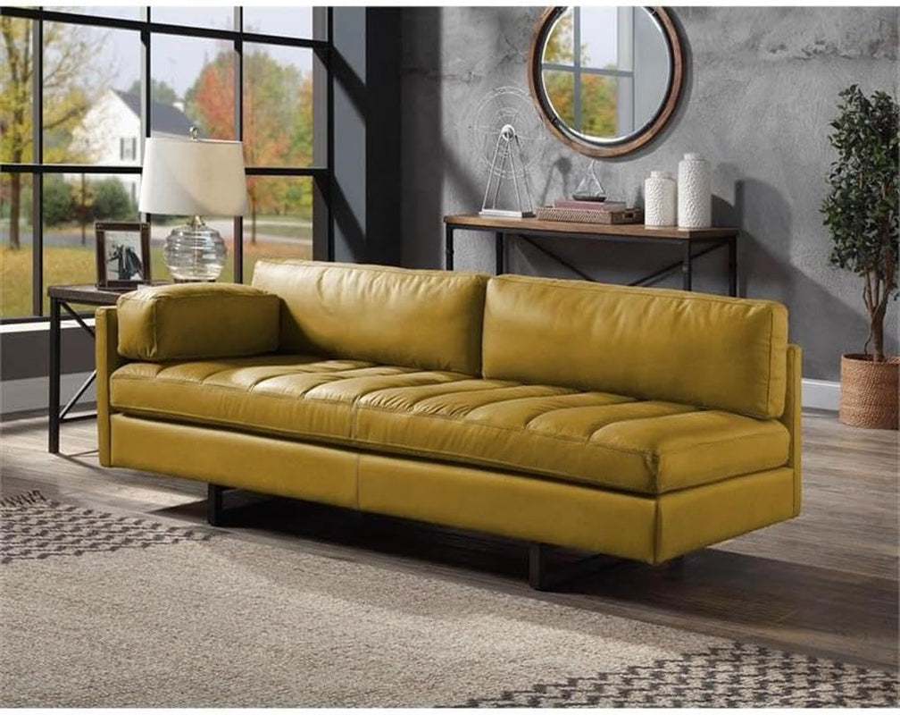 Yellow sofa in a living room setting with decor elements.