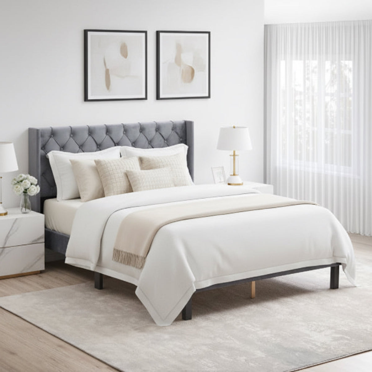 Gray upholstered bed with striped bedding in a bedroom setting.