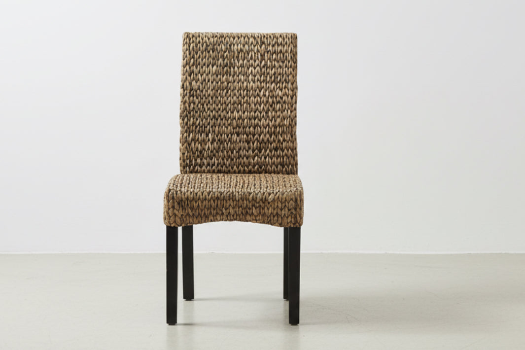 Two woven chairs with brown pattern on a white background