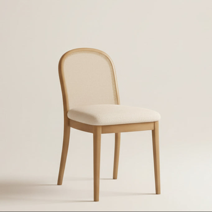 Dining room with wooden table and chairs against a warm orange wall.