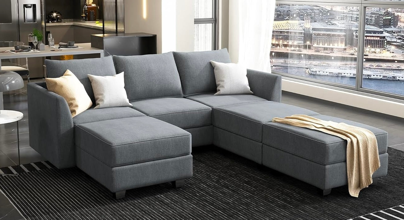 Gray sectional sofa with cushions in a modern living room setting.