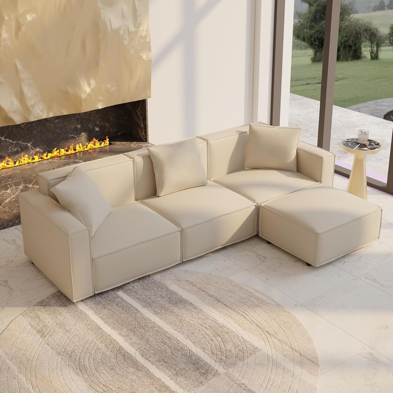 Beige sectional sofa in a modern living room with a fireplace and outdoor view.
