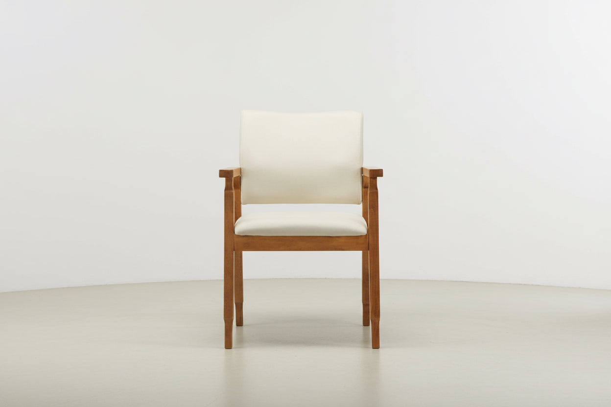 Wooden chair with cream cushion on a white background