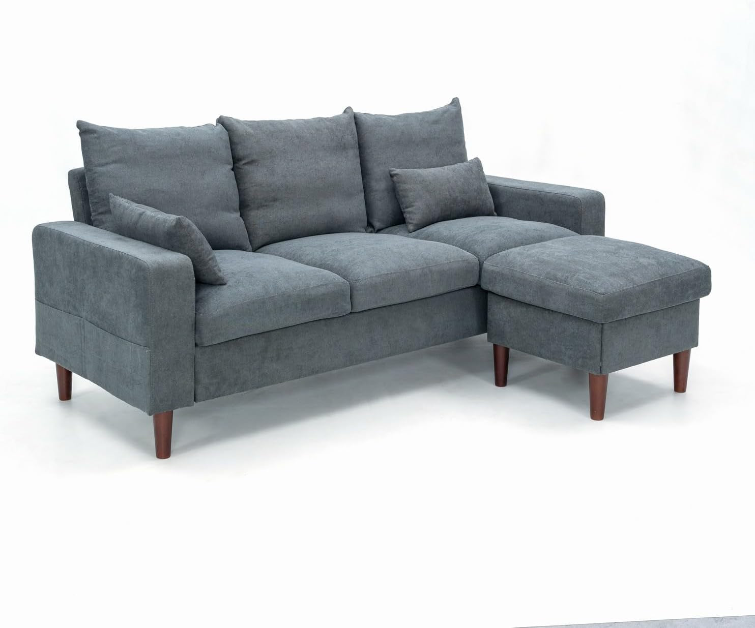Gray sectional sofa with ottoman on a white background
