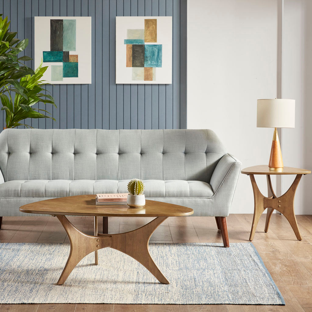 Modern living room with gray sofa, wooden coffee table, and side table.