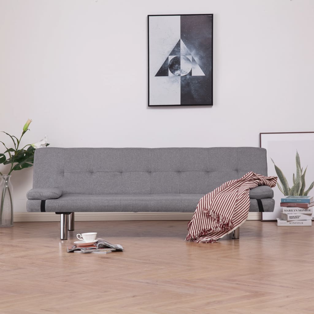 Gray sofa in a living room with a coffee table and decorative items.