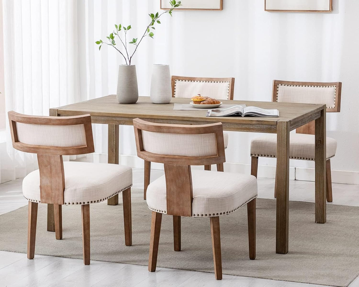 Dining room with wooden table and chairs in a bright room.