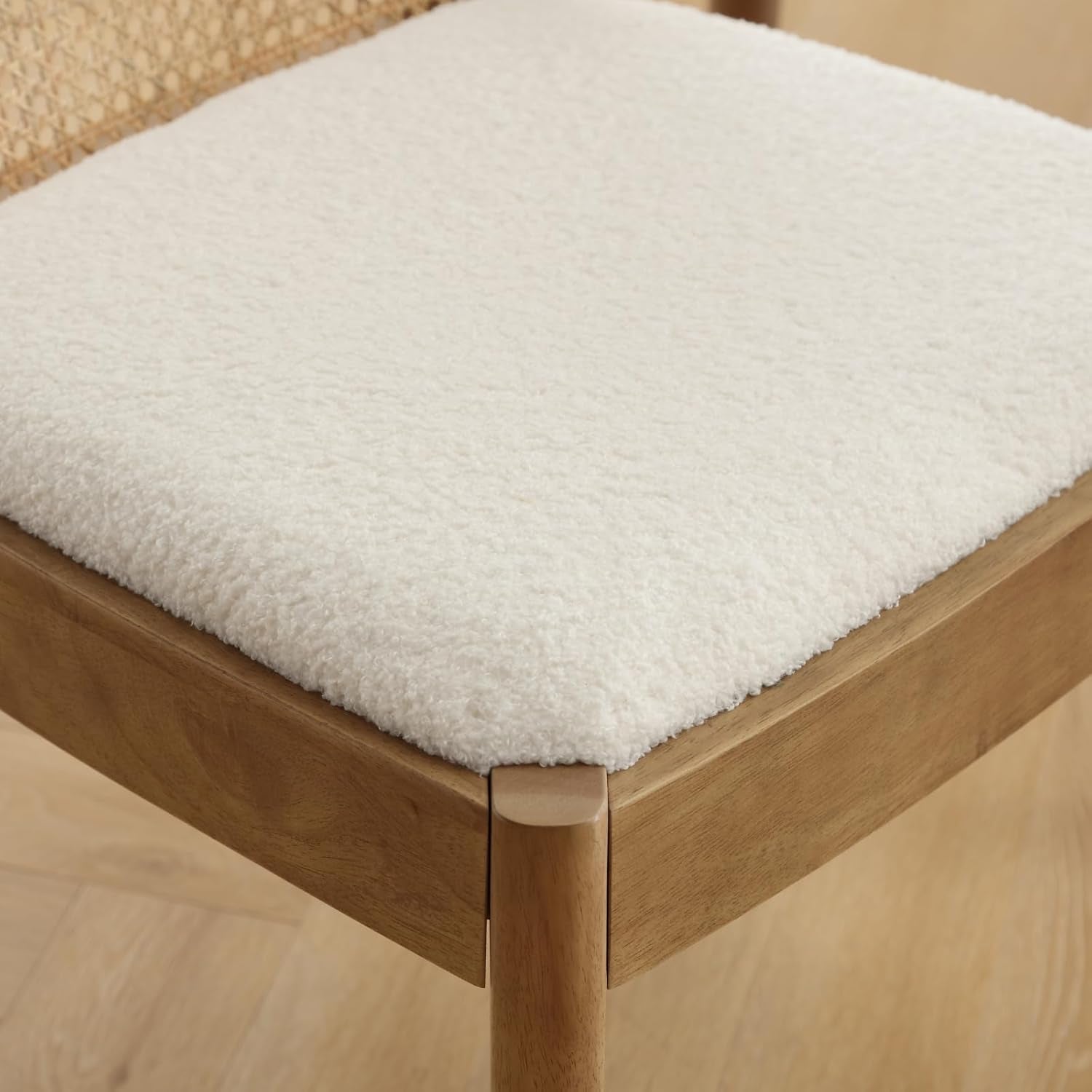 Wooden stool with a white cushion on a wooden floor