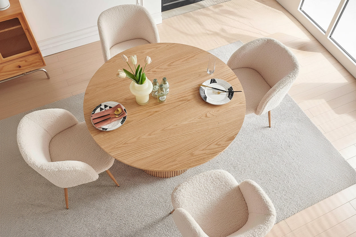 Round wooden table with decorative items in a modern living room setting, featuring text about the table's design and features.