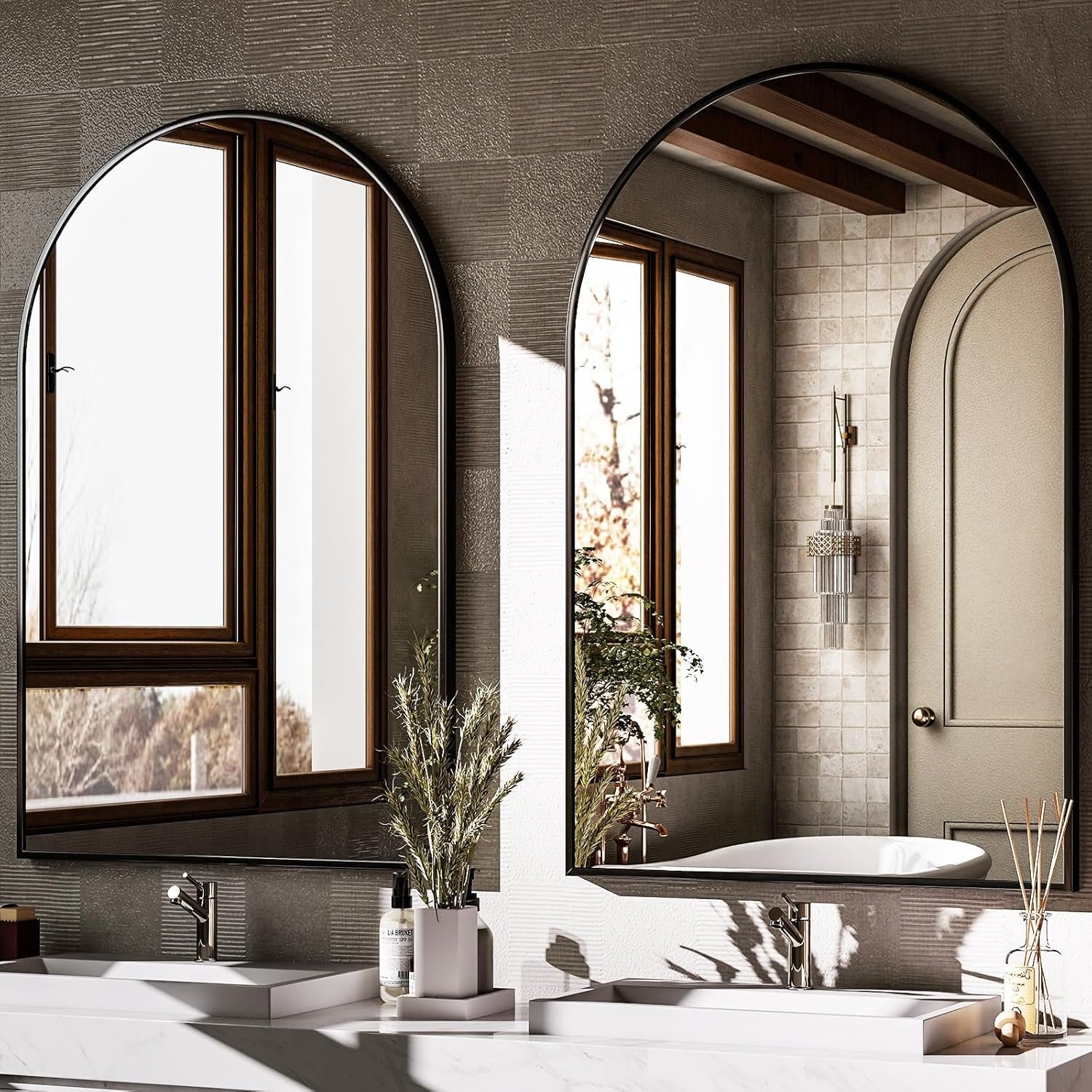 Bathroom with arched mirrors reflecting a snowy landscape