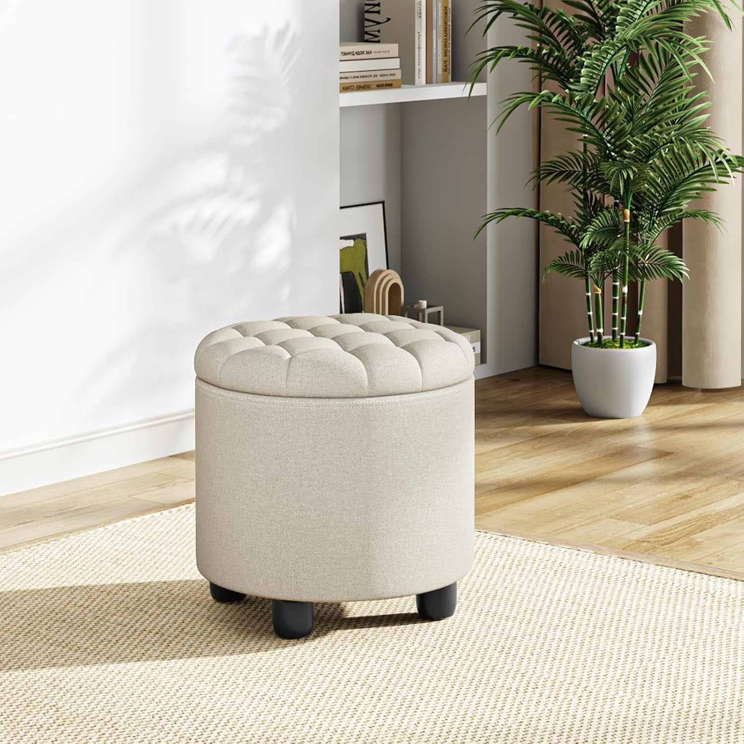 Round beige ottoman with tufted design in a room with a plant and bookshelf.