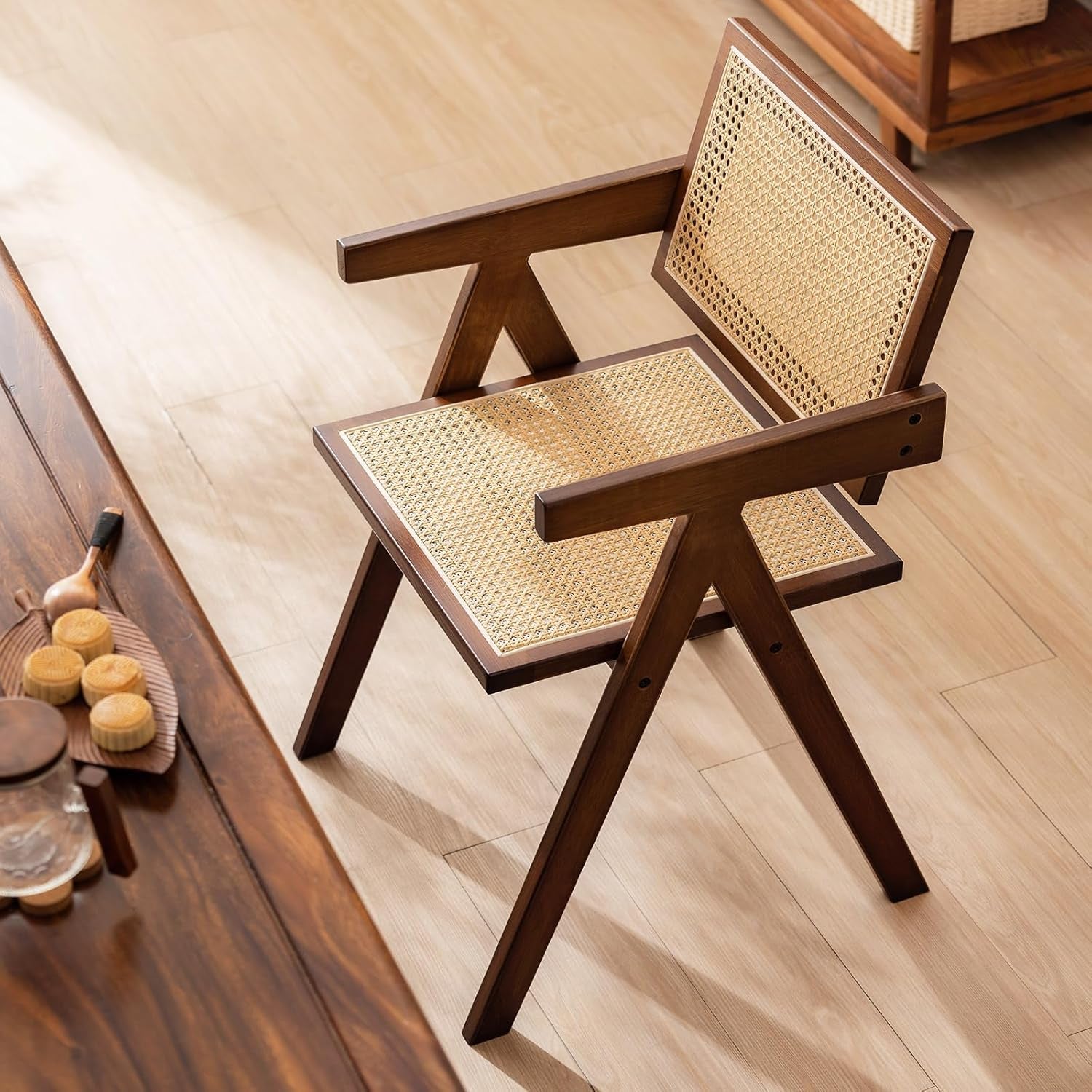 Wooden chair with wicker seat and backrest on a wooden floor.