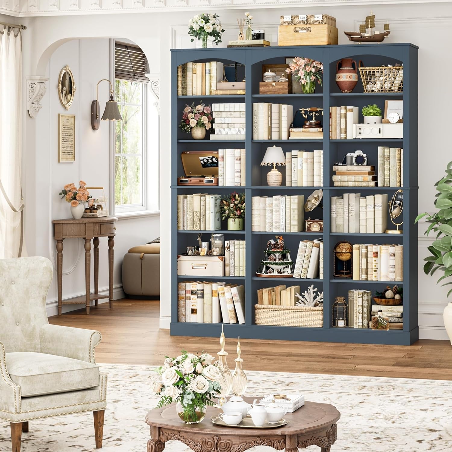 Blue bookshelf filled with books and decorative items in a living room setting.